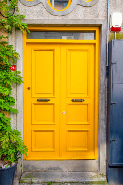 istock Yellow wood and an old door with a gray front. 1490125490