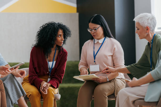istock Group of confident mature women talking while visiting business conference 1490126172