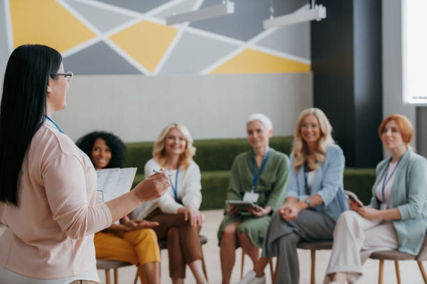 istock Group of mature women listening to speaker while visiting training class together 1490126218