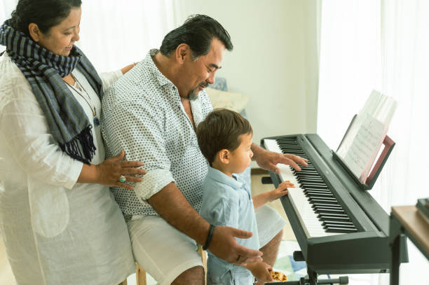 istock Grandparents with grandson playing piano 1490126814
