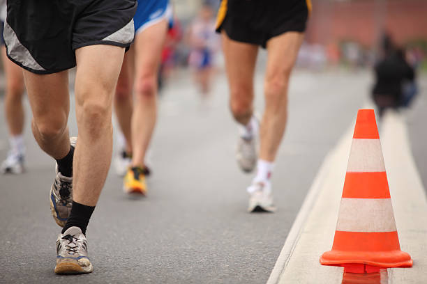 istock Runing man's legs near cone on asphalt 149012926