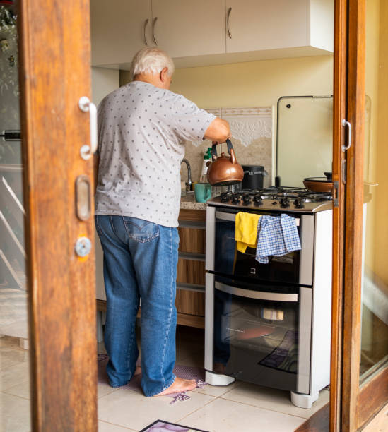 istock Senior man preparing coffee in vacation rental home kitchen 1490129442