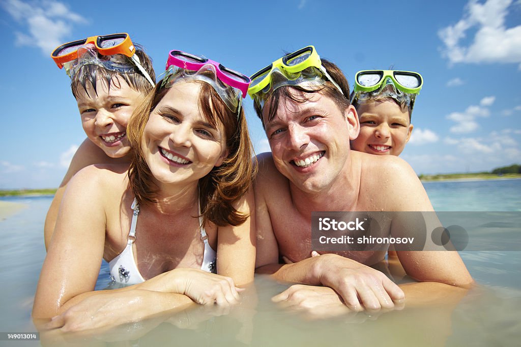 On vacation Photo of happy family looking at camera during summer vacation Adult Stock Photo