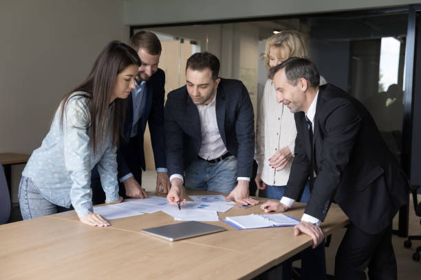 istock Diverse business team brainstorming on paper marketing reports 1490130263