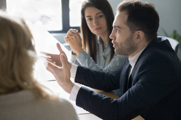 istock Confident businessman talking to colleagues on office meeting 1490130778