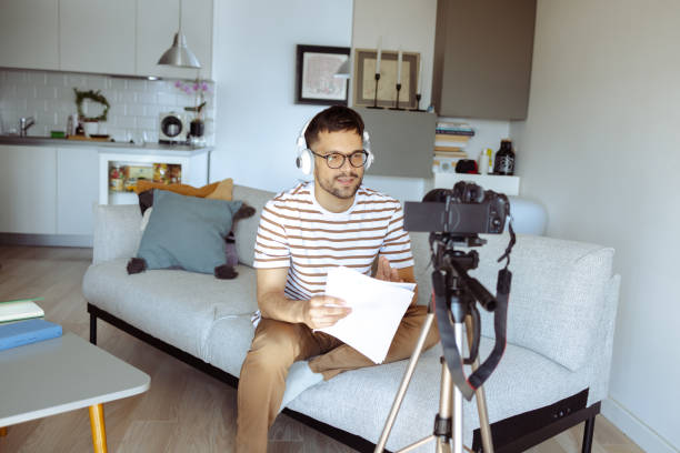 istock Young man recording a video at home 1490133355