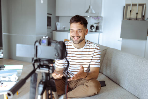 istock Young smiling man recording vlog and talking 1490133356