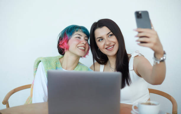 istock Two close friends take a break while working on the computer and take a selfie with the phone. 1490133824