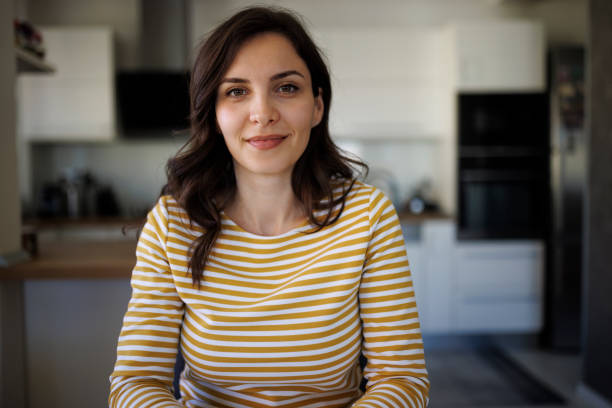 Portrait of smiling confident young woman at home stock photo