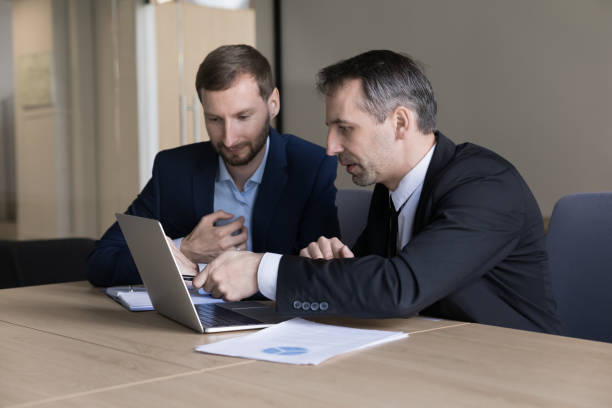 istock Worried business executive and assistant watching content on Internet 1490134684