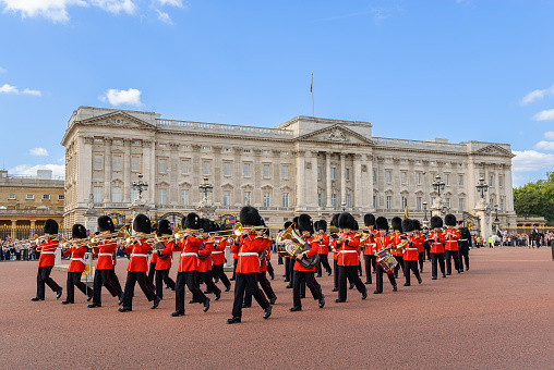 London Buckingham Palace front facade in a summer sunny blue sky day. Built in 1701 beside St James Park. Changing of the Guard takes place on the Buckingham Palace forecourt. It is the official residence of the British monarch in London.