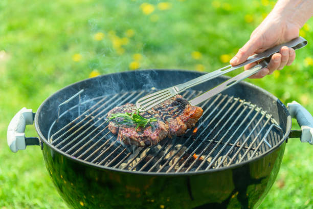 istock Delicious juicy steak roasting on a grill in spring sunlight 1490135872