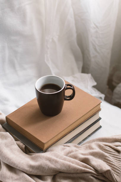 istock Simple composition of indoor relaxation with coffee and books. 1490137973