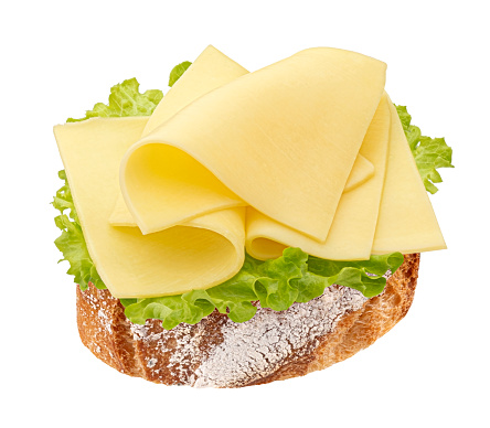 Cheese sandwich, gouda slices on piece of bread with lettuce leaves isolated on white background with clipping path, full depth of field, top view