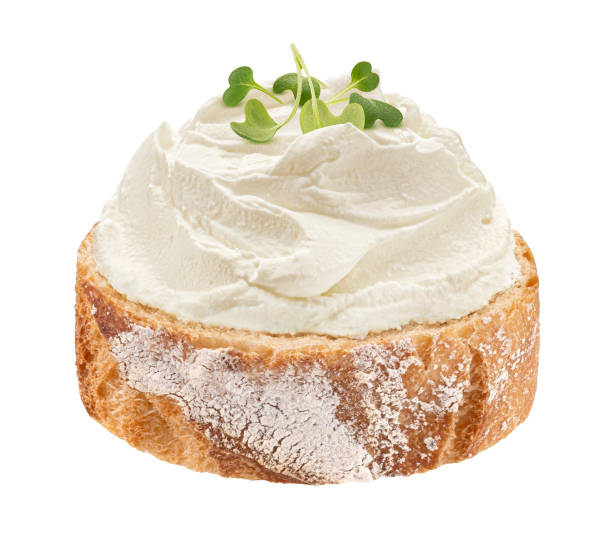 Baguette slice with cream cheese swirl isolated on white background