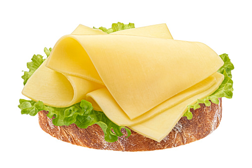 Gouda slices on bread, cheese sandwich with salad leaves isolated on white background, full depth of field