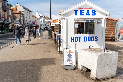 Whitby, United Kingdom – May 05, 2023: A kiosk in the town of in Whitby, North Yorkshire, UK, selling teas and hot dogs to tourists