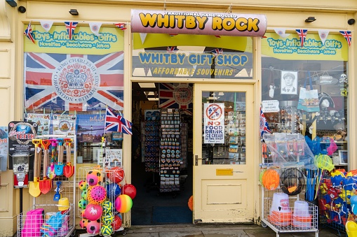 Whitby, United Kingdom – May 05, 2023: The seaside gift shop, 'Whitby Rock' by the harbour in the town of \nWhitby, North Yorkshire, UK, selling buckets and spades.