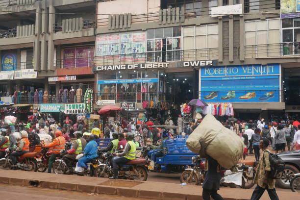 Traffic and pedestrians on a busy street in central Kampala stock photo