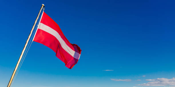 istock Flag of Latvia against blue sky. 1490146409