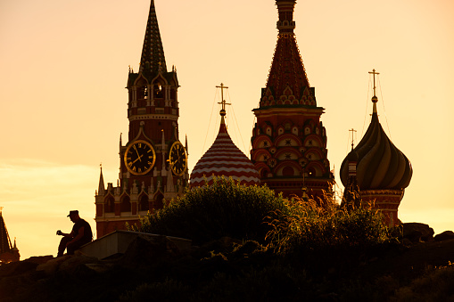 Silhouette of policeman in Zaryadye near Kremlin, Moscow, Russia. Landscaped Zaryadye Park is tourist attraction of Moscow. Scenic view of city landmarks at sunset in summer. Theme of travel in Moscow