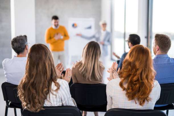 istock Entrepreneurs applauding on business presentation in board room. 1490155424