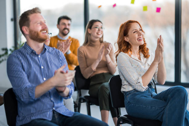 istock Group of entrepreneurs applauding on education event. 1490157725
