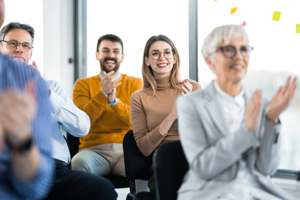 istock Group of entrepreneurs applauding on education event. 1490157909