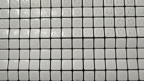 Arrangement of white square tiles lined up to form a pattern