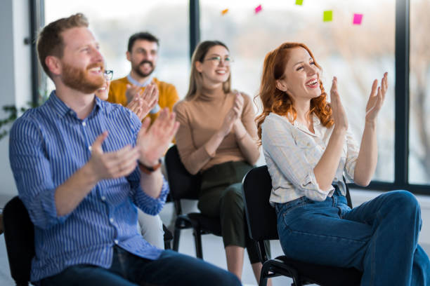 istock Group of entrepreneurs applauding on education event. 1490157959