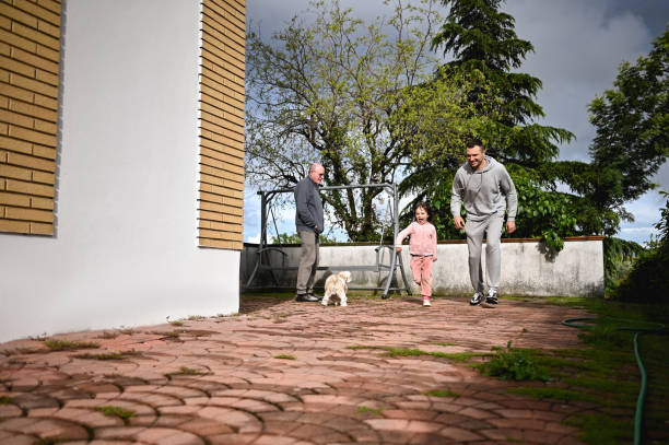 istock father with daughter playing and running in a yard. 1490171300