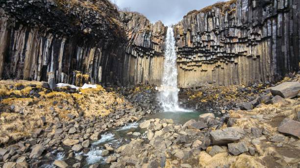 istock Stunning landscape of a majestic waterfall surrounded by rocks 1490171932