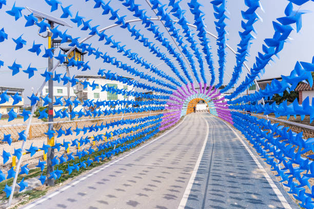 The arched passage is full of small windmills