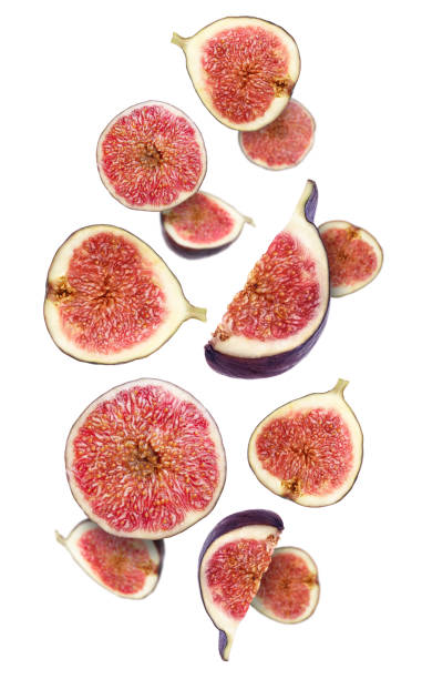 istock Tasty ripe cut figs flying on white background 1490188321