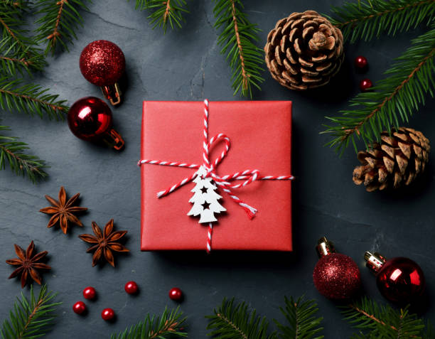 istock Flat lay composition with beautiful gift box and different Christmas decor on dark background 1490197276