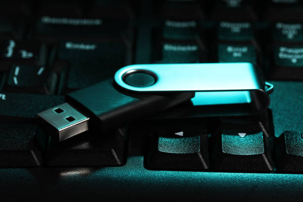 istock Modern usb flash drive on laptop keyboard, closeup 1490197714
