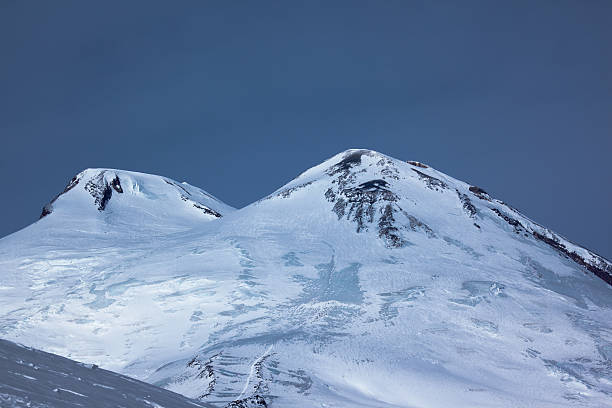 Two peaks of Elbrus Mount in the twilight stock photo
