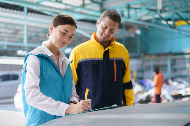 istock Woman and technician talking together in garage. 1490207912