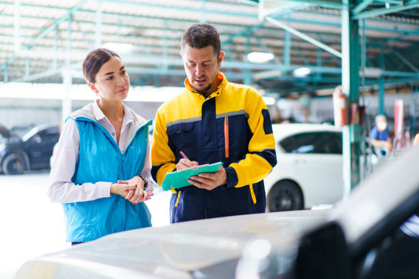 istock Woman and technician talking together in garage. 1490208050