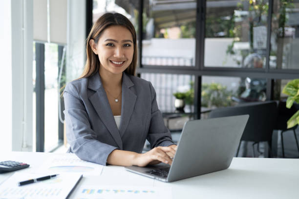 istock Beautiful confident businesswoman typing on laptop computer while working at her office desk. 1490210563
