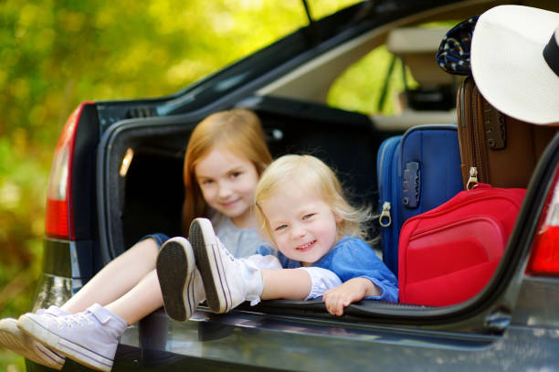 istock Two adorable little sisters sitting in a car 1490210656