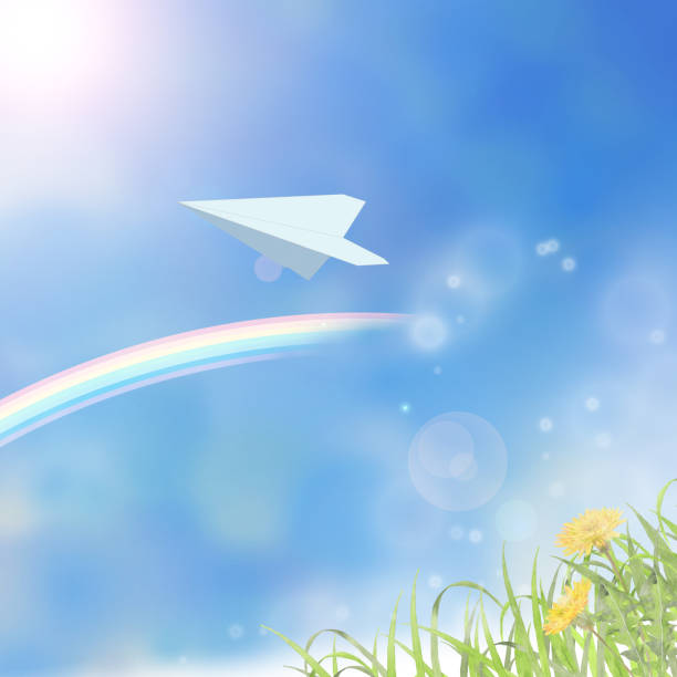 istock White paper airplane in blue sky with dandelion field 1490216404