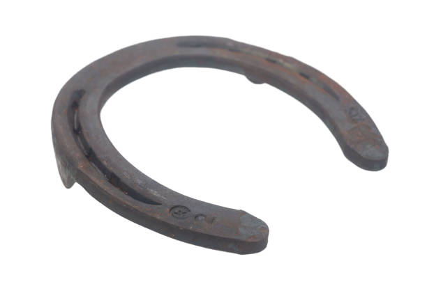 istock Closeup rusty steel horseshoe isolated on white background 1490216418
