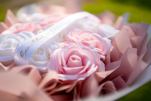 Bouquet of roses and gift box on white background
