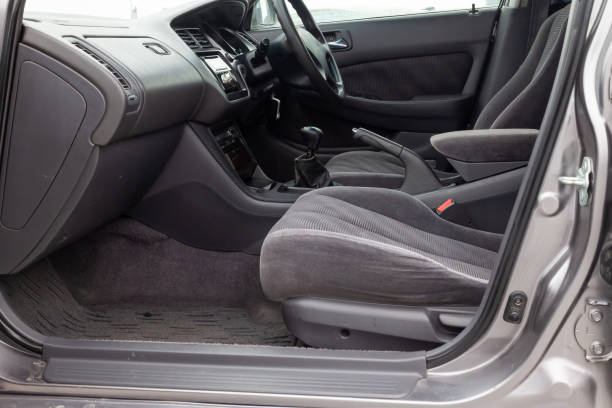 istock Comfortable front seats inside the car: the driver and passenger, tied with genuine black leather, modern interior design, the steering wheel covered with black wood and a luxurious center console. 1490219826