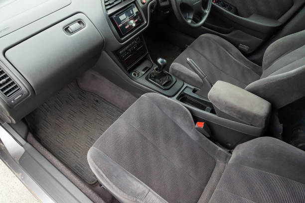 istock Comfortable front seats inside the car: the driver and passenger, tied with genuine black leather, modern interior design, the steering wheel covered with black wood and a luxurious center console. 1490220916
