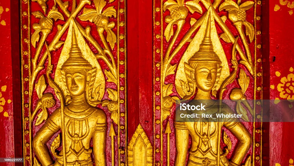 Ornate fresco at a Buddhist temple Golden fresco at the Wat Hosian Voravihane Temple in Luang Prabang Laos Architecture Stock Photo