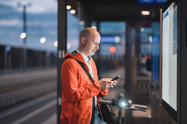 istock man checking train times at arrival depature board at railroad station platform 1490223947