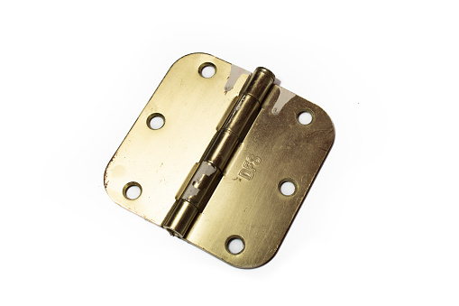 brass old antique recycled hinge with paint dripping marks used to attach or join things but still allow for movement