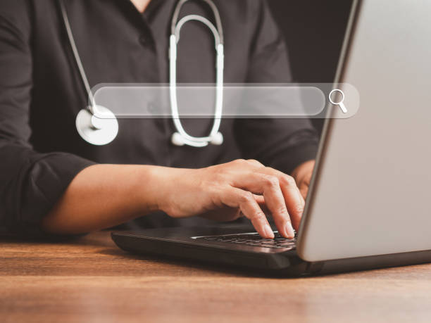 istock Close-up of hand a doctor using laptop and internet for searching information on web browser 1490230947
